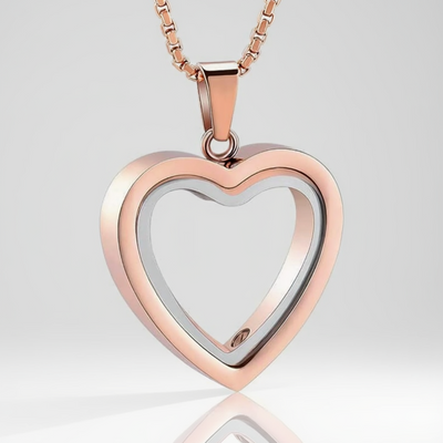 Heart-shaped pendant with rose gold and silver finish on a white background