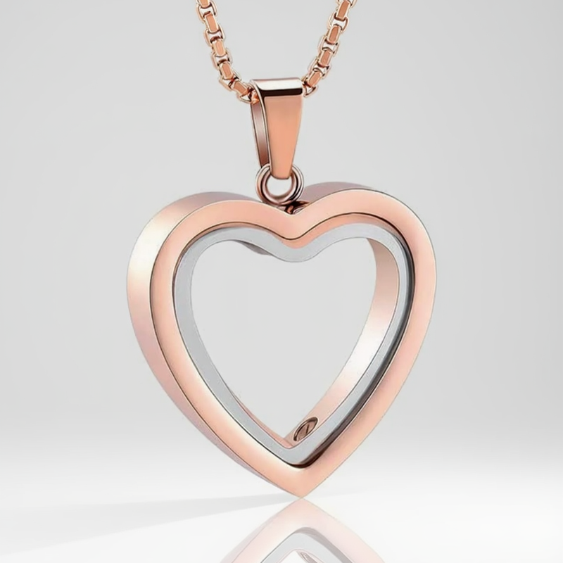 Heart-shaped pendant with rose gold and silver finish on a white background
