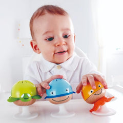 Baby playing with colorful toys on a high chair