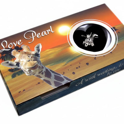 A rectangular gift box for 'Love Pearl' fashion jewelry, featuring a giraffe and savanna sunset illustration on a white background. The box has a circular cutout showing a black insert with a giraffe emblem.