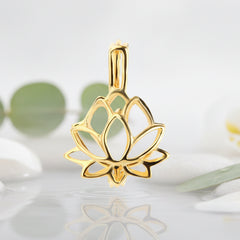A gold lotus flower pendant charm with a polished finish, shown on a white background with a green leafs.