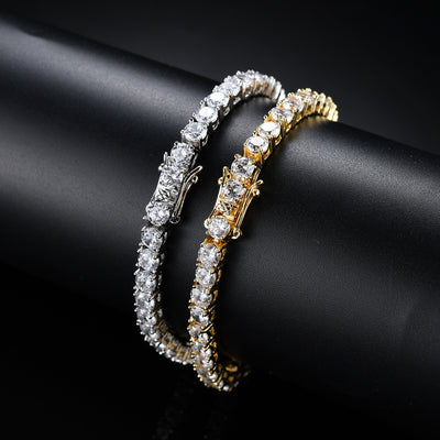 Gold and silver bracelet with clear stones on a black background
