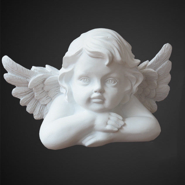 Mini cherub angel statue with detailed wings and a serene resting pose, crafted in smooth white resin and displayed against a dark background for a classical home décor look.