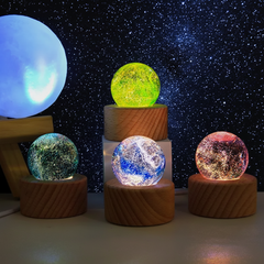 A selection of illuminated glass spheres in multiple colors arranged for display.