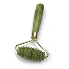 Green skin exfoliation roller with gold handle on a white background