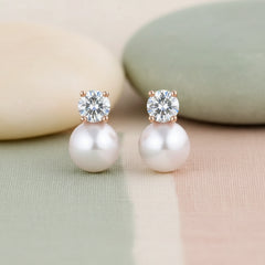 Pearl earrings with Swarovski crystals on a white background