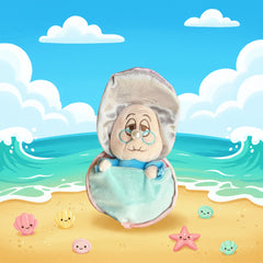 Cute oyster‑style plush with glasses and a pearl nose sitting on a colorful cartoon beach scene with smiling seashells and starfish.