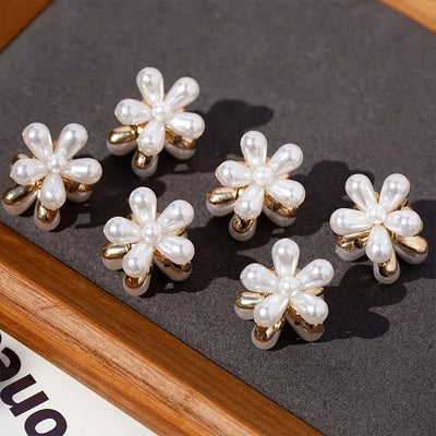 Set of pearl flower earrings on a dark surface