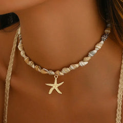 Necklace with starfish charm and shell beads on a person's neck