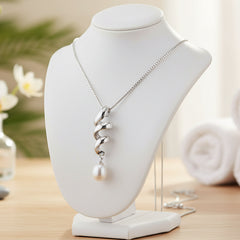 Silver white pearl necklace on a jewelry stand