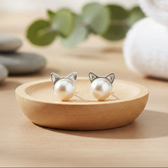 Pair of pearl earrings with cat ear design on a white background