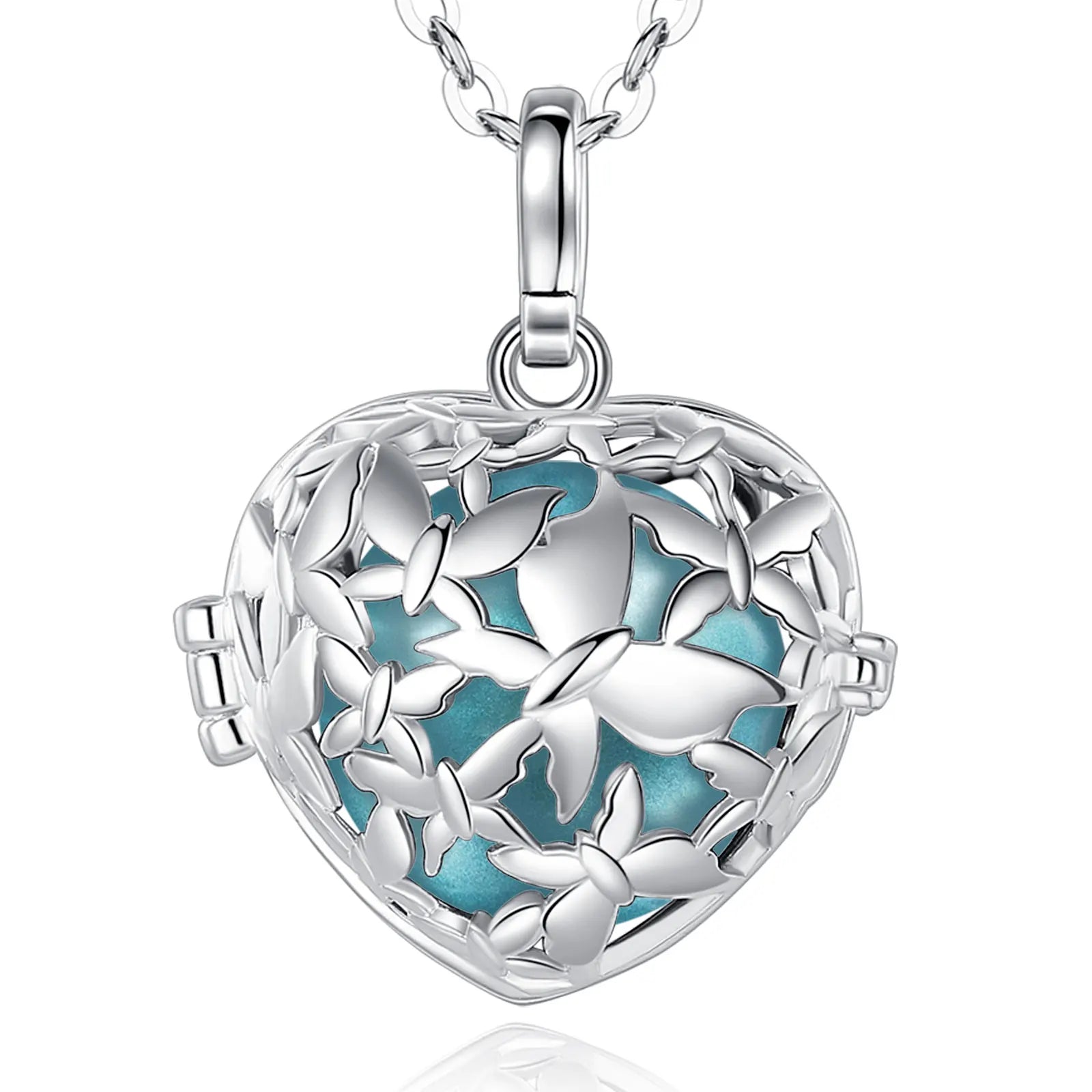 A silver heart-shaped locket pendant necklace with a butterfly cutout design and blue green enamel inlay, shown on a white background with a faint reflection.