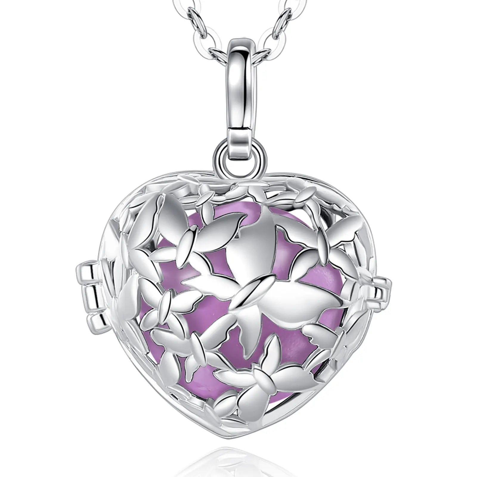 A silver heart-shaped locket pendant necklace with butterfly cutouts and a light purple floral inlay, shown on a white background with a reflection below.