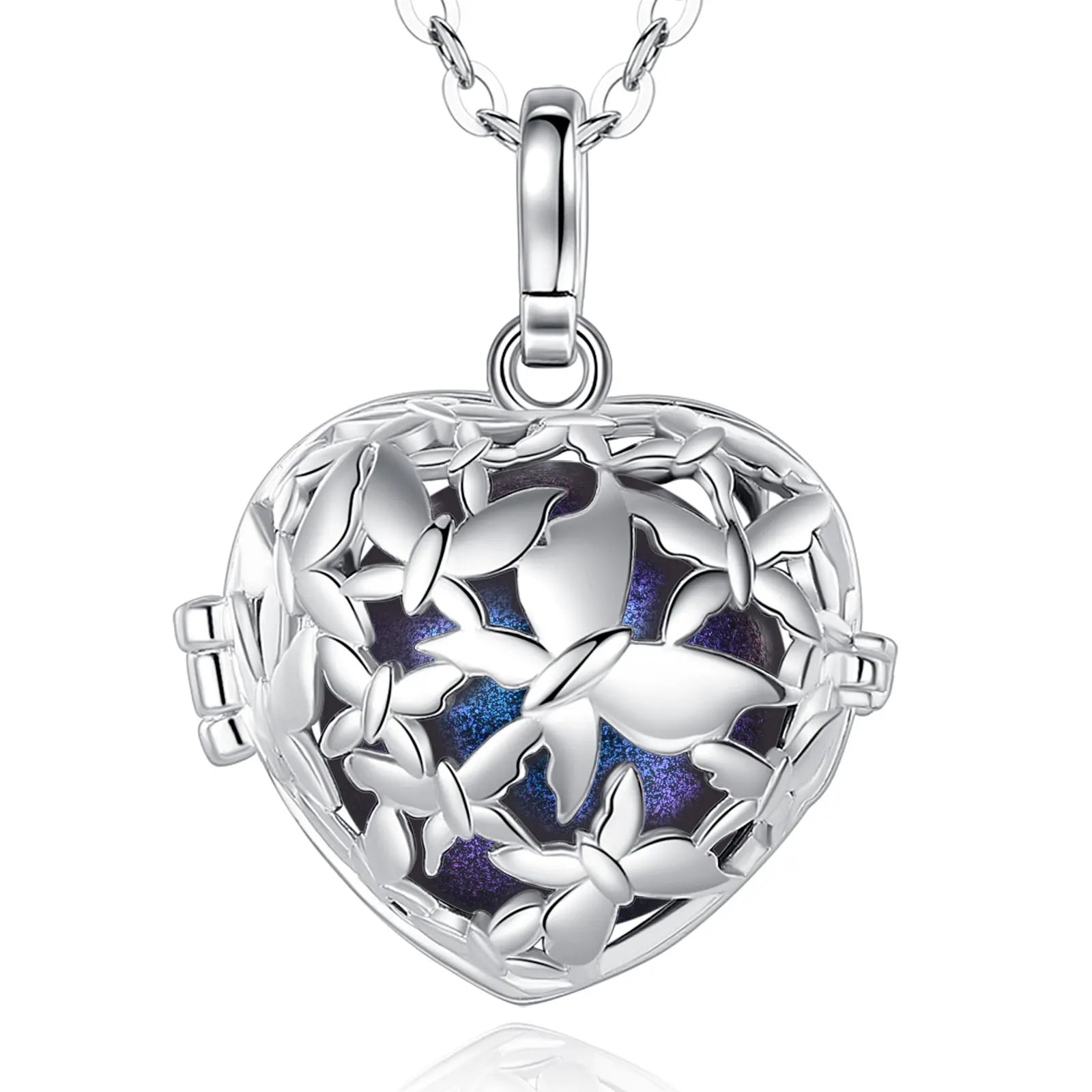 A silver heart-shaped locket pendant necklace with a butterfly cutout design and a blue purple glittery interior, shown on a white background with a reflection.
