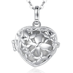 A silver heart-shaped locket pendant with a butterfly design, hanging from a silver chain against a white background.