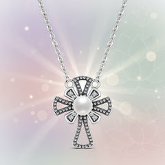 Sterling Silver cross pearl necklace and clear crystals on a soft pastel background