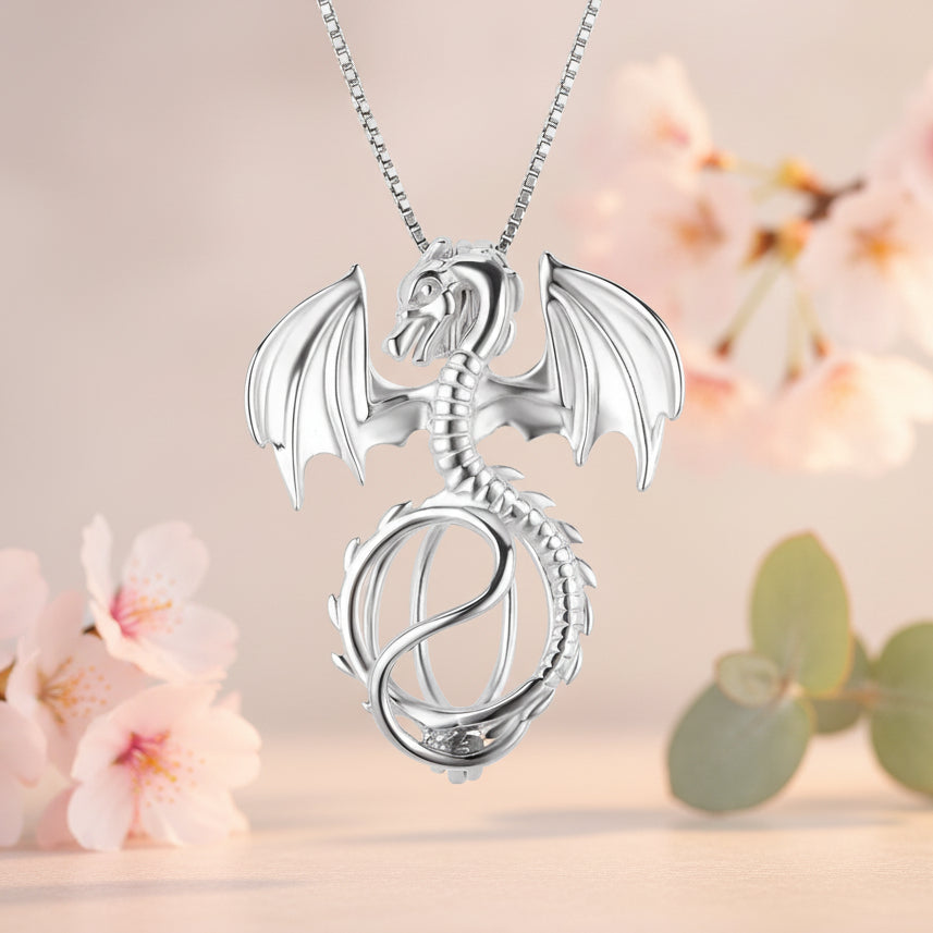 Sterling Silver dragon pendant necklace on a soft orange background