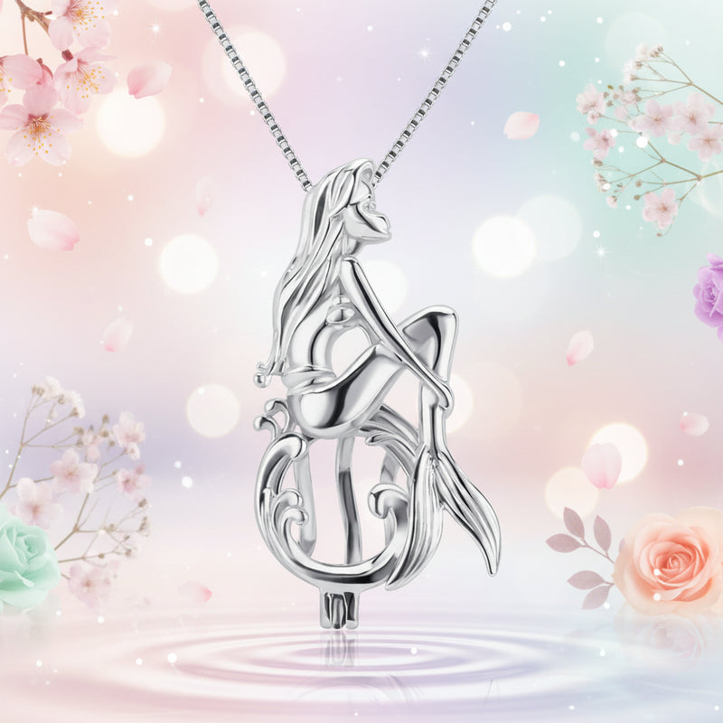Sterling silver mermaid pendant necklace on a pastel background featuring a polished mermaid figure on a stylized wave form with a box chain.