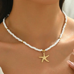 Pearl necklace with a gold starfish pendant on a person