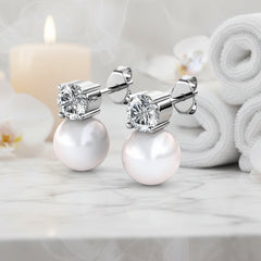 White Pearl and Swarovski crystal stud earrings on a white background