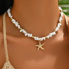 Necklace with starfish charm worn by a person, with a blurred background