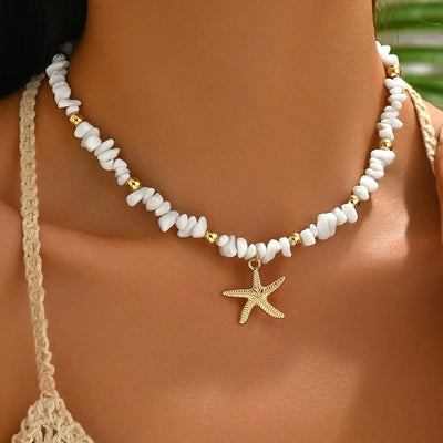 Necklace with starfish charm worn by a person, with a blurred background