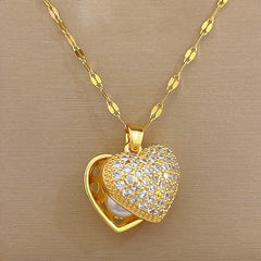 Gold heart-shaped necklace with a chain on a beige background