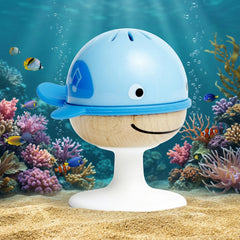 Blue and beige toy whale with a sealife background