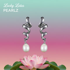 Sterling silver spiral drop earrings with white freshwater pearls displayed above a pastel background and pink lotus flower