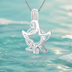 A sterling silver starfish pearl cage against aqua colored water and bubbles background